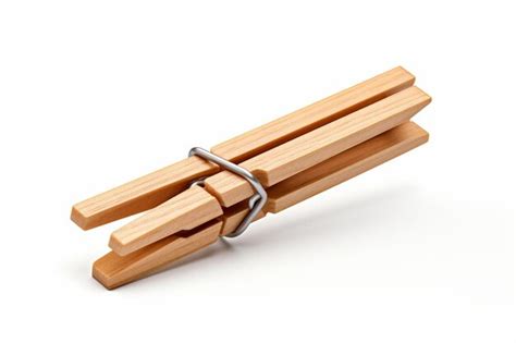 Premium Photo Pair Of Wooden Clothes Pegs With Metal Hook On A White