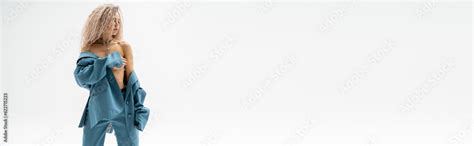 Passionate Female Model With Dyed Ash Blonde Hair Obscuring Naked Breast With Hand And Posing In