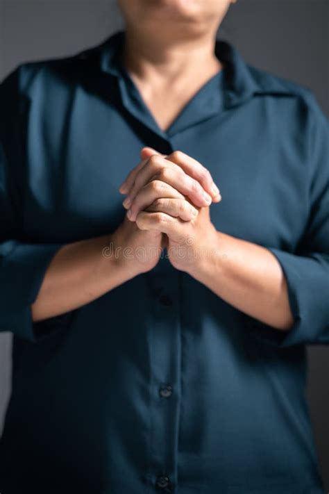 Woman Raises Her Hand In Prayer With Deep Faith In God Worshiping