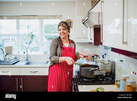 Mature Woman Enjoying Cooking At Home Stock Photo Alamy