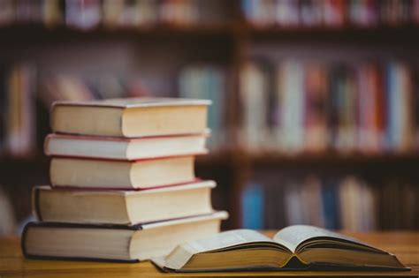 Books on desk in library | Premium Photo