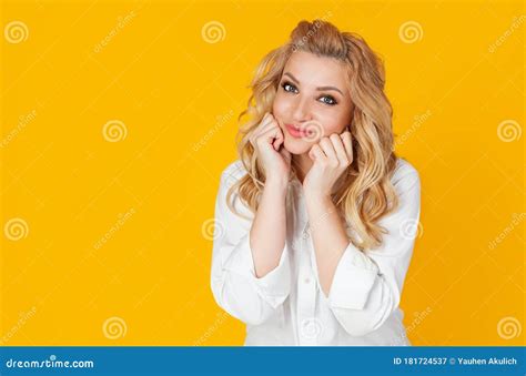Woman Blonde Smiling Excited Touches Herself On The Cheeks Happy Patiently Waiting For The Long