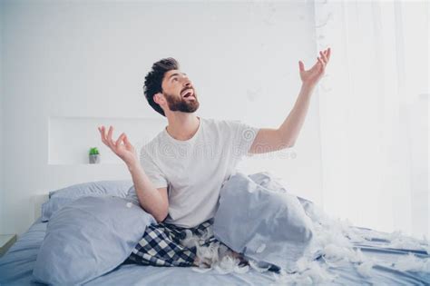 Photo Of Handsome Excited Mature Guy Dressed Sleepwear Sitting Bed Rising Arms Indoors Room Home