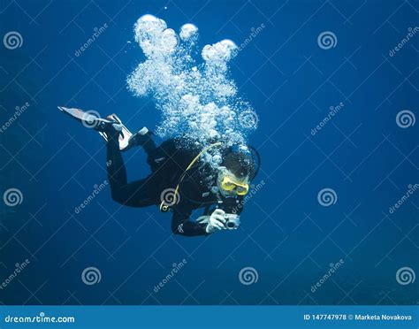 Scuba Diver Taking Underwater Photo In Deep Blue Water Stock Photo