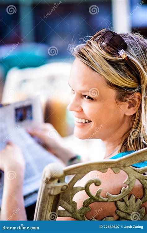 Smiling Blonde Woman Reading Newspaper Outdoors Stock Image Image Of Beauty Casual 72669507