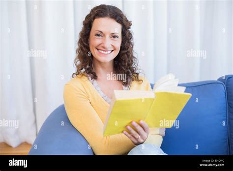 Pretty Brunette Relaxing On The Couch And Reading Book Stock Photo Alamy