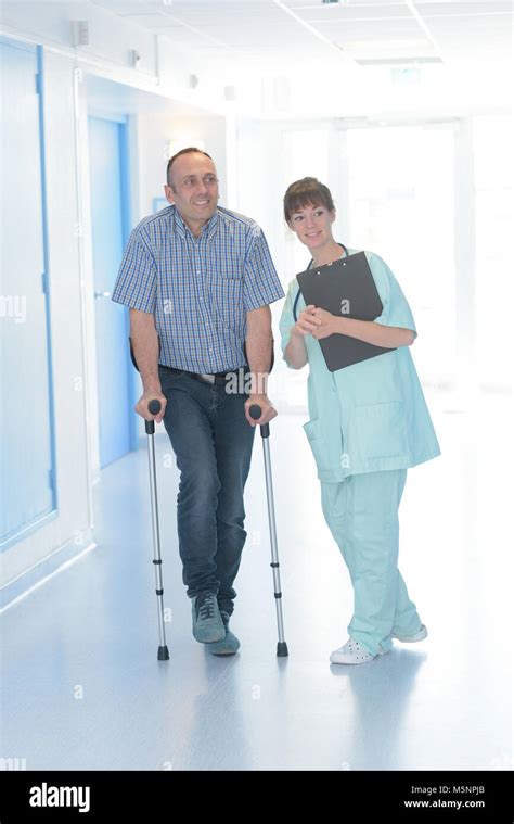 Nurse With Patient On Crutches Stock Photo Alamy