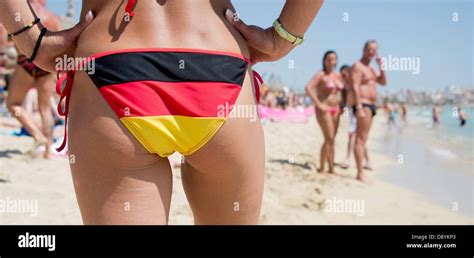 A German Tourist Stands In A Bikini With The German Flag On It On The Beach In Arenal Mallorca