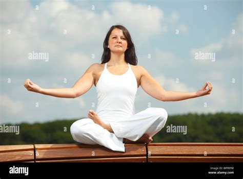 Yoga 'half lotus pose' / yoga exercise Stock Photo - Alamy