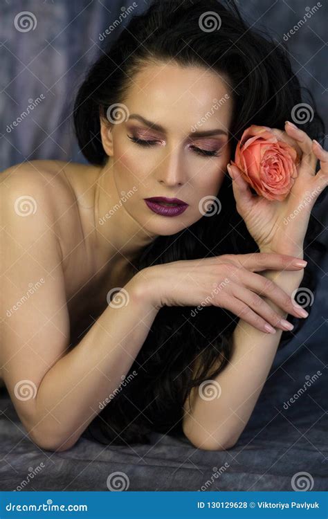 Beauty Shoot Of Tender Brunette Lady With Perfect Makeup Holding Stock Photo Image Of Female