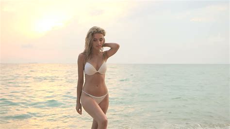 A Beautiful Sexy Woman In White Bikini Sunbathing By The Sea Stock Footage Video 1054348