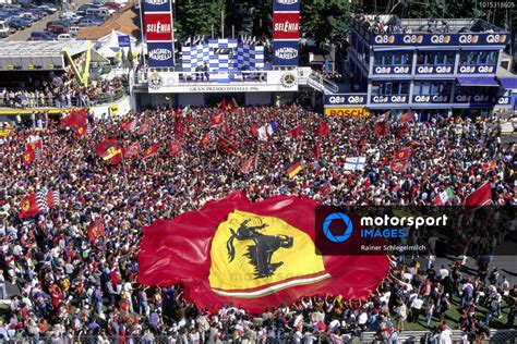 The Tifosi Celebrate In Front Of The Podium With A Large Ferrari Flag