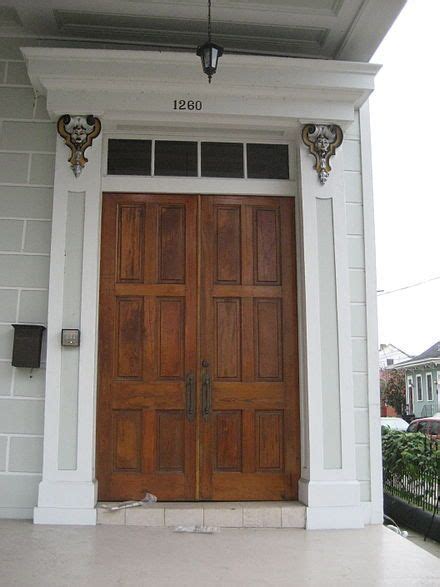 an image of a wooden door on the side of a house with text overlaying it