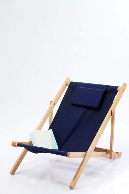 Premium Photo Books On Blue Deck Chair Against White Background