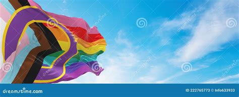 Lgbtq Inclusive Progressive Pride Flag Waving In The Wind At Cloudy Sky