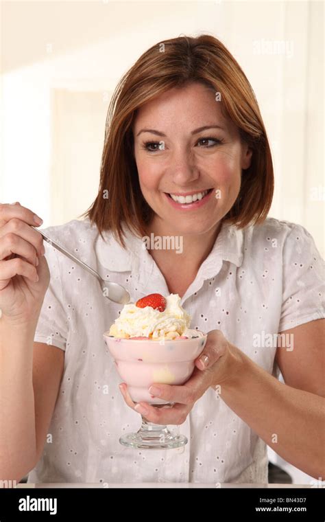 Woman Eating Ice Cream Sundae Stock Photo Alamy