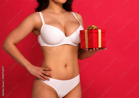 Sexy Voluptuous Busty Woman In White Lingerie Holding A Gift Box Red Background Stock Photo