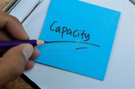 Concept Of Capacity Write On Sticky Notes Isolated On Wooden Table