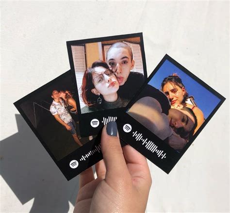 Someone Holding Up Four Polaroid Photos With The Same Image On Them As