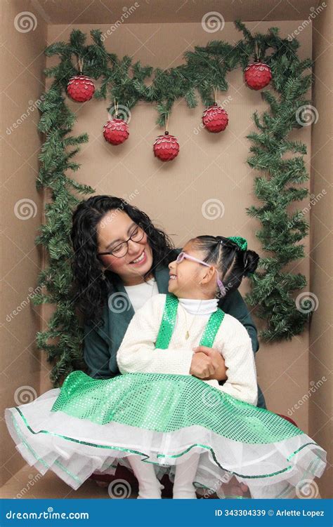 Mom With Her 5 Year Old Brunette Daughter With Eyeglasses Inside A Decorated Gift Box To