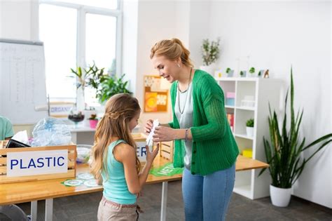 Premium Photo Giving Small Award Blonde Haired Teacher Wearing Green Cardigan Giving Small