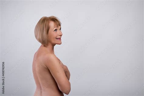 Graceful Aging Beautiful Mature Woman With Nude Body Posing On Light Studio Background Copy