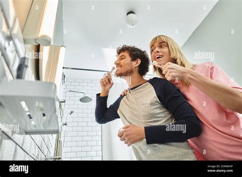 A Loving Gay Couple Shares A Playful Moment While Brushing Their Teeth Together Stock Photo Alamy