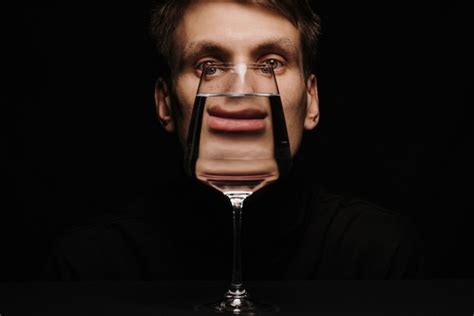 Premium Photo Unusual Portrait Of A Man Looking Through A Glass Of