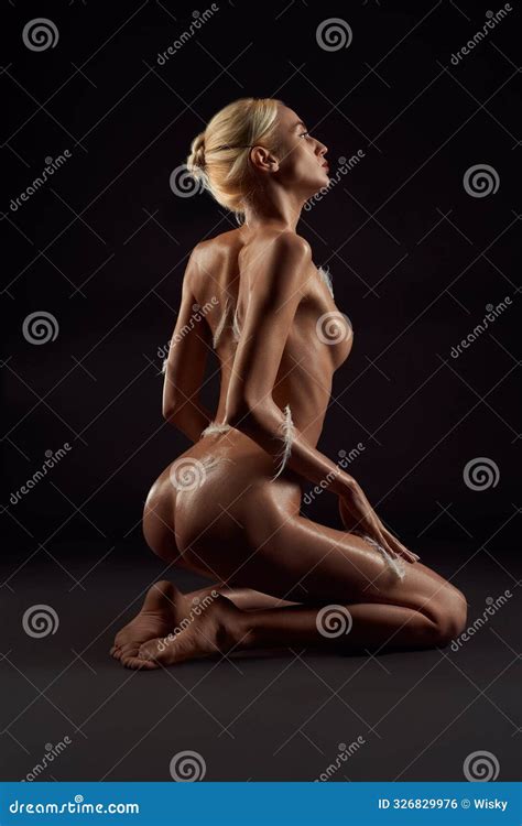 Naked Woman In With Feathers Stuck To Her Body Sitting On Floor Stock Photo Image Of Concept