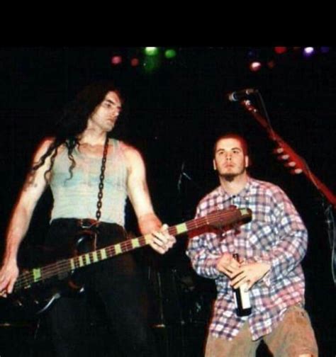 Two People Standing On Stage With Guitars