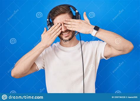 Hispanic Man With Beard Listening To Music Wearing Headphones Covering