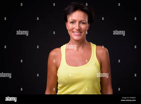 Mature Beautiful Woman With Short Hair Against Black Background Stock Photo Alamy