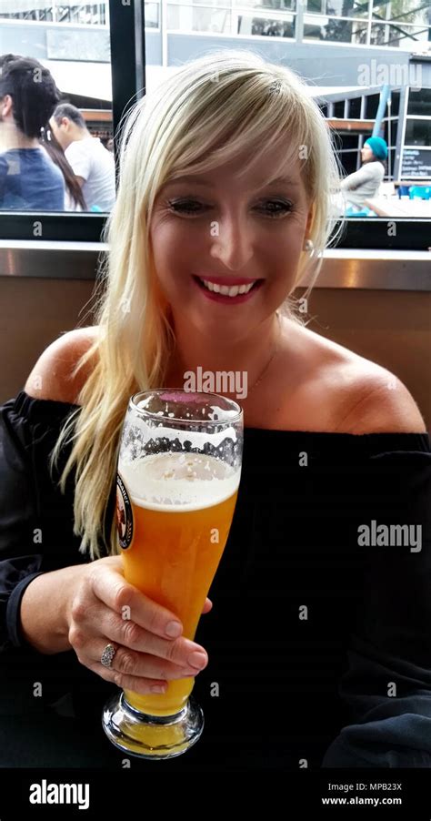 Blonde Female Drinking Beer Stock Photo Alamy