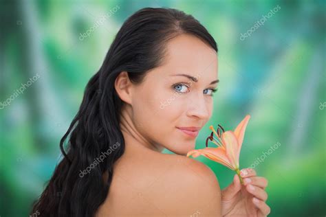 Beautiful Nude Brunette Smelling Lily Stock Photo Wavebreakmedia 50046959