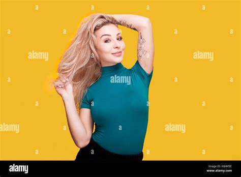 Gorgoeus Blonde Woman Posing To The Camera On Yellow Background Stock Photo Alamy