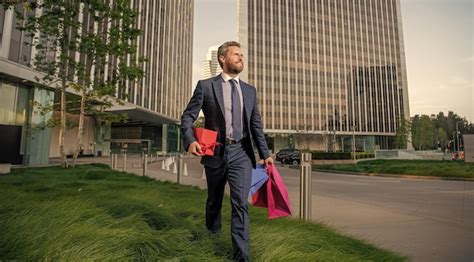 Premium Photo Happy Charismatic Mature Businessman In Suit Hold Packages And Gift Box Outside