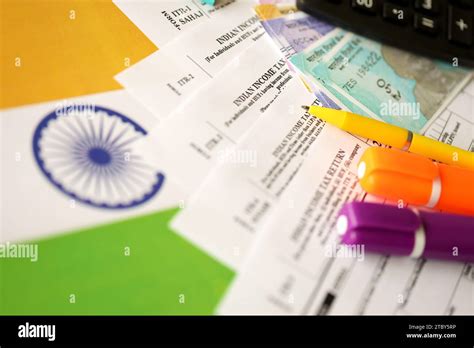 Indian Income Tax Return Blank Form With Pen And Indian Rupees Bills On