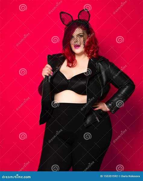 Cute Plus Size Brunette With Black Bunny Ears In Leather Jacket And Underwear Posing On Red