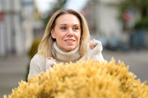 Blonde Woman Standing Behind Yellow Flowers Stock Photo Image Of Side Attractive