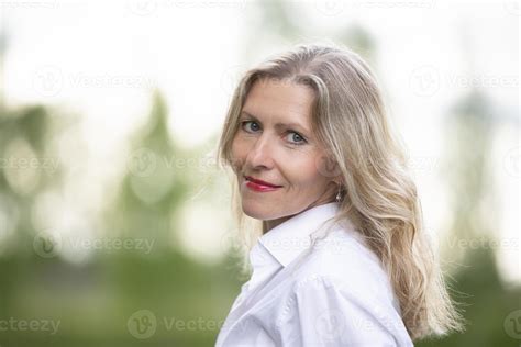 Portrait Of A Beautiful European Middle Aged Woman Fifty Year Old Blonde Woman With A Well