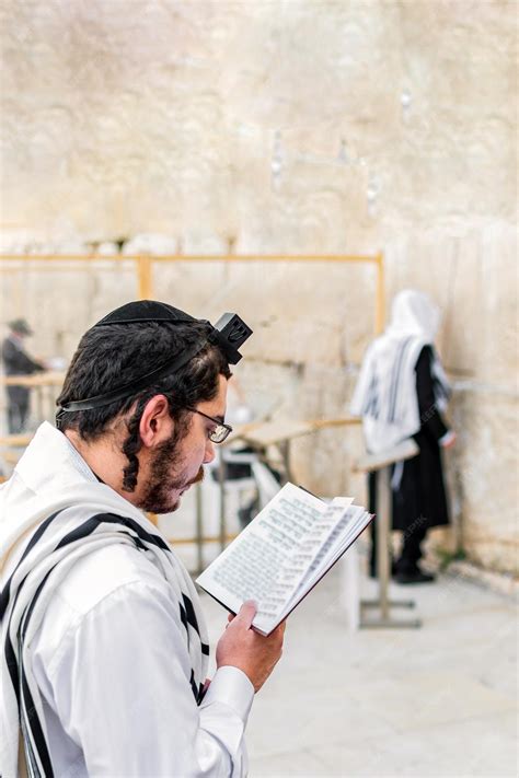 premium photo young orthodox jewish man praying  phylacteries