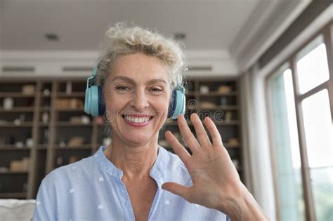 Mature Woman In Headphones Looking At Web Camera Waving Hand Stock Image Image Of Camera