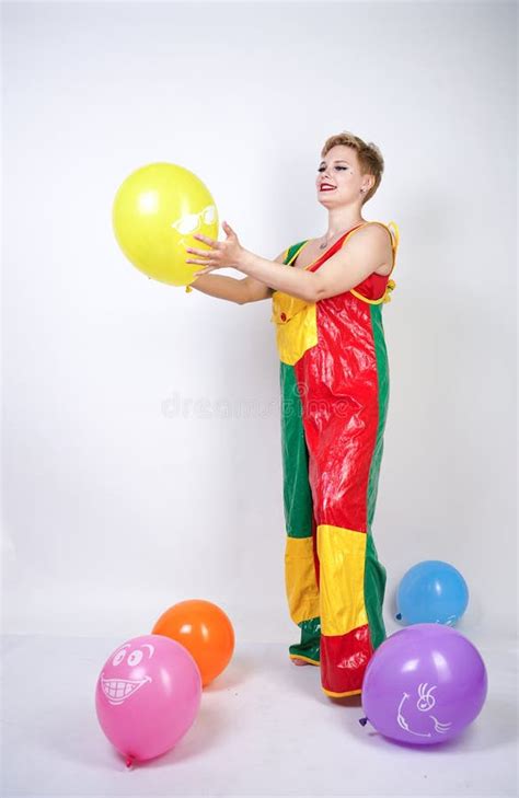 Cute Chubby Girl With Short Blonde Hair And Plus Size Figure In Bright Colored PVC Jumpsuit