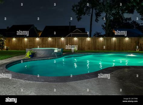 A Backyard Swimming Pool And Jacuzzi Hot Tob At Night Stock Photo Alamy