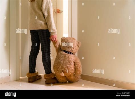 Little Girl Holding Hand Of Teddy Bear And Going To Her Room