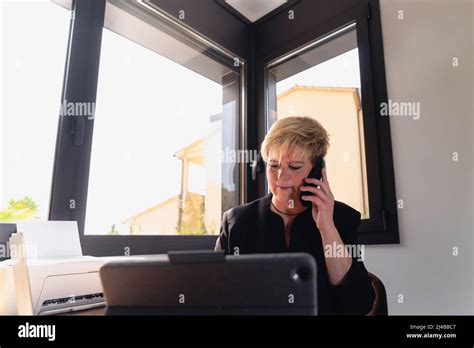Mature Business Woman With Blonde Hair Working In Her Home Office Using Laptop Computer Low