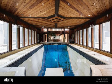 An indoor swimming pool inside of an abandoned mansion Stock Photo - Alamy