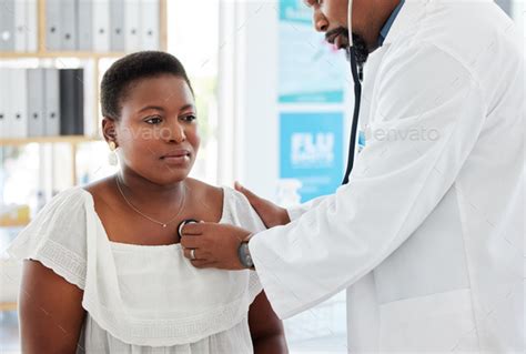 Doctor Listening To The Lungs Of A Patient Mature Doctor Using A Stethoscope During A Patient