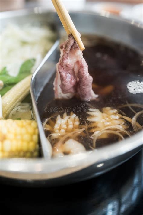 Man Holding Slice Beef Out From Hot Pot Shabu Shoyu Soup Base Stock Image Image Of Slice