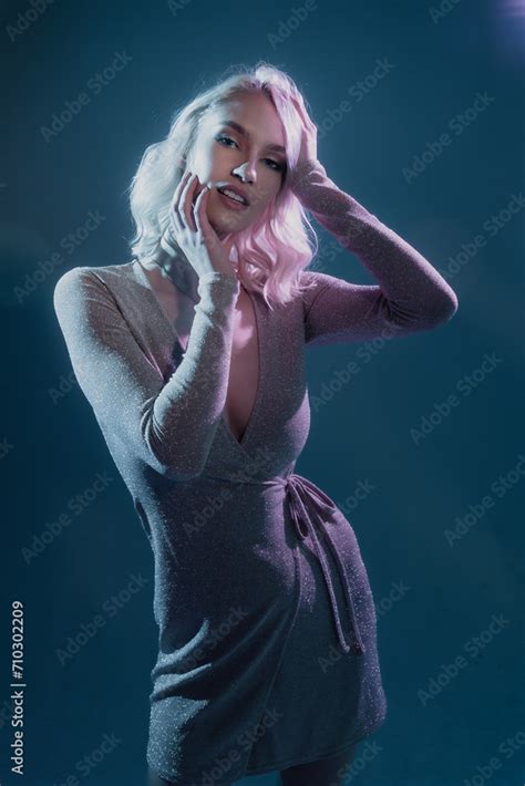 Stunning Blonde Woman With Mesmerizing Blue Eyes Strikes A Pose In Studio With Creative